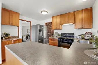 The kitchen has a lot of storage space, including a pantry (to the left) by the eating nook.