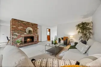 Another view of the living looking toward the front entry and the kitchen beyond.