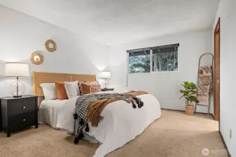 The primary suite is spacious and also takes in the southerly views and sunlight.