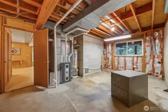 There is a work shop area that houses the newer furnace and hot water heater and is ready for sheetrock and your creativity!