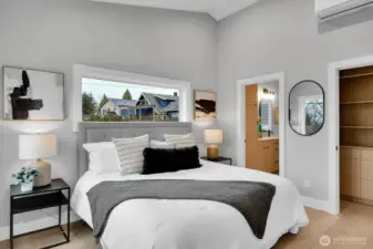 Upstairs primary bedroom with vaulted ceilings, walk in closet and ensuite bath