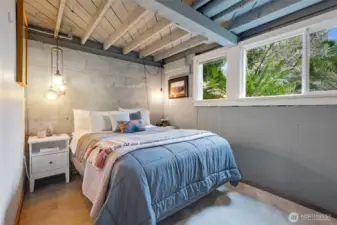 The primary looks out onto the view of ferns and greenery.