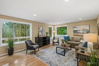 This is a wonderful gathering place right off the kitchen. The large windows let the outdoor light in, and can lighting adds to the brightness of this room.