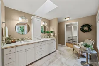 The primary bathroom has been recently updated with white cabinetry, quartz countertops, tile backsplash, tile flooring, and a beautiful freestanding soaking tub.