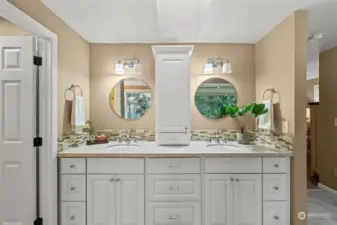 Another view of the elegant double vanity in the primary bath with no-edge sinks and plenty of storage.