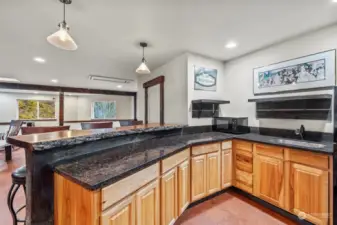 Granite countertops and a live-edge bartop with room for stools also adds to the rustic decor.