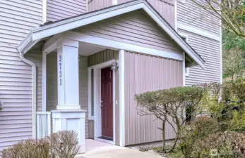 A vibrant red front door greets you with personality and warmth—inviting you into a peaceful retreat.