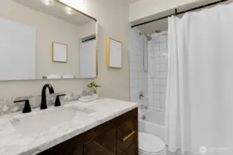 Remodeled bathroom with marble accents.