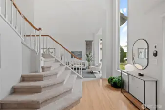 The entry unfolds into beautifully appointed Living and Dining spaces, perfect for entertaining.