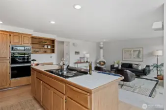 The Kitchen extends into a welcoming Family Room, where a custom wood-burning stove creates the perfect ambiance for quiet evenings or lively conversation.