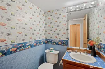 Back on the main level, just past the entry, is a cozy half-bath setting for your use, and the convenience of your guests.