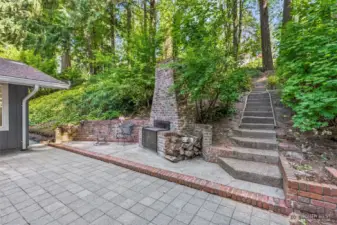Exterior Wood Fireplace and Trails Throughout the Backyard