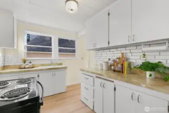 From the dining room, enter into the kitchen (entry to the right of the windows). The kitchen is ready for your vision or to use as-is.