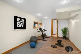 This room is adjacent to the rec room and could be used as a home gym or storage. Room is virtually staged.