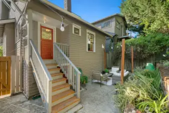 When you exit the kitchen, you come out to this covered porch and stairs down to the patio/backyard.
