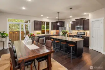 Open concept on the main floor between kitchen, dining, & living rooms