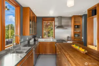Kitchen features stainless steel and German greenstone countertops.
