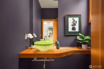 One of two powder rooms on the main floor features a one-of-a-kind blown glass sink.