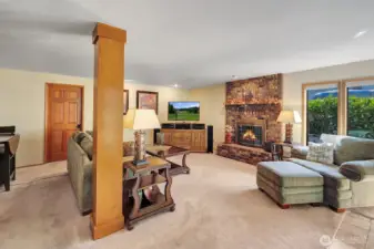 Family room semi-open to kitchen features brick fireplace