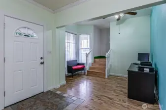 Main entry door to the left. nice entry area with main staircase going upstairs.  You'll appreciate the width of the stairs for moving items in the home.   Tall ceilings really open up rooms.