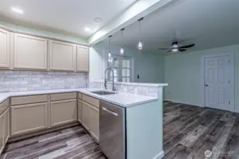Second view of the kitchen & dining room.  Second main floor bathroom thru closed door is a 3/4 bath.  PLEASE NOTE There is also a second main floor bedroom off the rear of the kitchen not pictured.  It has a exterior door that might suit a business owner.