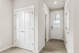 Entry with garage entrance featuring EV charger. Photos are for representational purposes only. Colors and finishes may differ.