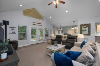 Great room with vaulted ceiling and french doors that lead to the back deck. Pellet stove.