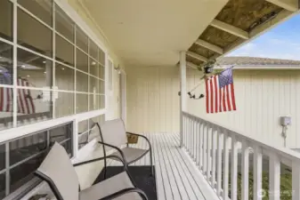 Inviting west-facing covered front porch—an ideal spot to relax and unwind while enjoying afternoon sun and evening sunsets.