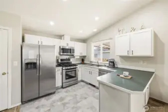 Well-designed kitchen featuring a functional layout with plenty of cabinet storage and a convenient pantry, making meal prep and organization a breeze.