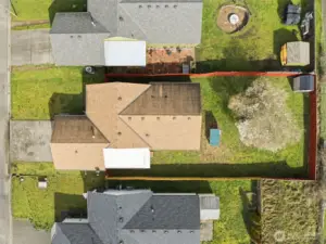 Bird’s-eye aerial view looking directly down at the property, highlighting the home, yard, and surrounding lot layout.