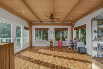 On the other side of the Great room is the sun room; a perfect library, art studio or additional office space.