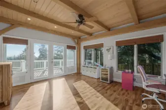 The sun room has its own access to the deck and has lots of windows that let in the incredible views.