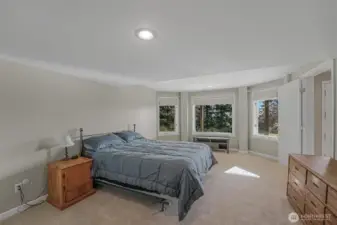 The daylight basement’s bedroom is complete with an en-suite and washer/dryer.