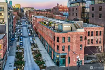 Main Street corridor just outside, leading east into Pioneer Square’s core in under a block