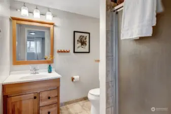 Updated primary ¾ bath with tiled shower and floors
