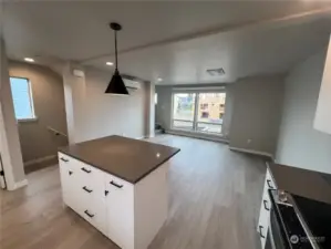 This end units Kitchen + living area receives more natural light from the additional windows