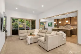 As you continue into the home, you'll be wowed by the stunning custom living, kitchen, and dining area
