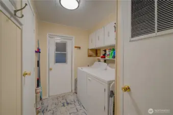 laundry room with door to main bath and to the back covered proch