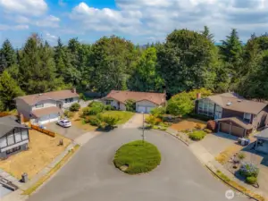 This home is nestled quietly at the back of a cul-de-sac that has a center island.