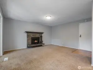 The comfortable family room is open to the kitchen and features a new wood stove insert with blower that creates bone-warming heat for cozy winter nights.