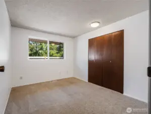 The first of the bedrooms looks out over the home's side yard.