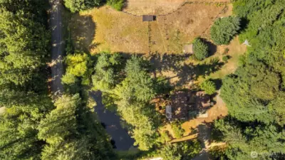 Fields on the N side of the property w/ house/gar on the S side