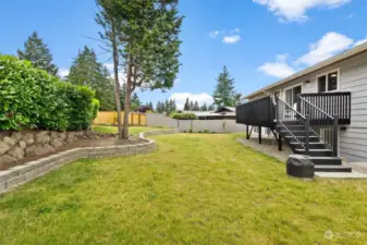 The new retaining wall adds interest and separation to this beautiful open space. There is plenty of garden area for you to turn this backyard into your own oasis.