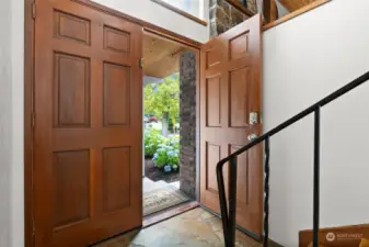Large paneled wood doors open to a split level entry with quiet spaces for everyone to enjoy.