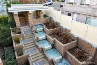 From a secure gate on 2nd Ave NE, you are welcomed to the grounds with flowing pools that create great ambiance.