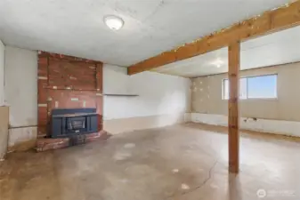Spacious basement area with wood stove