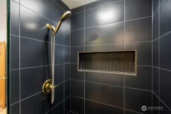 Walk in shower with modern tile and finishes.