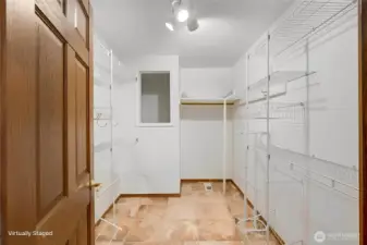 Large walk in closet with extra storage space.