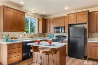 The spacious kitchen has an island for prep and casual dining