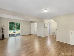 Convenient slider brings in natural light and back yard access.